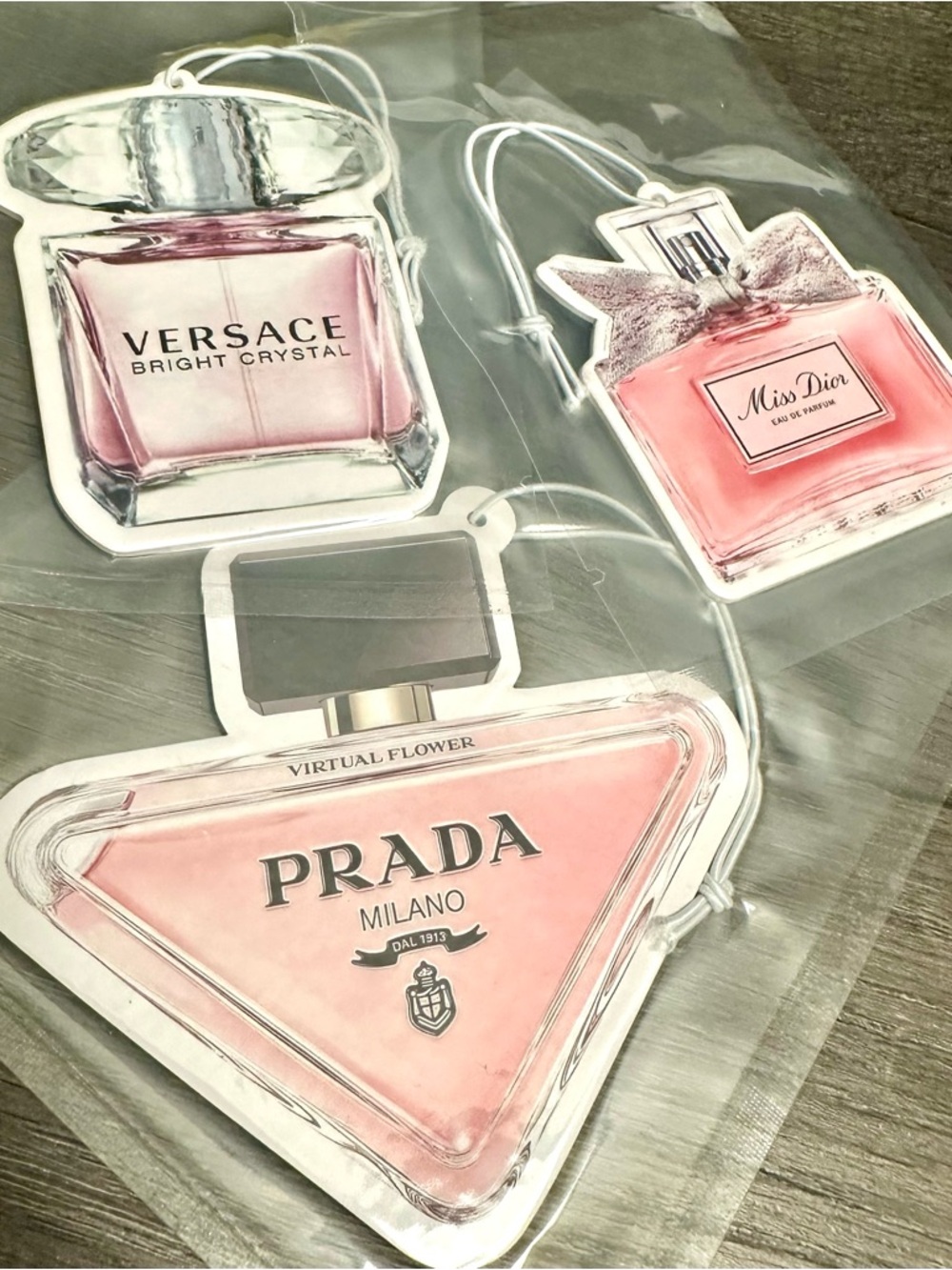 Set of (3) shaped air fresheners featuring stunning designs.